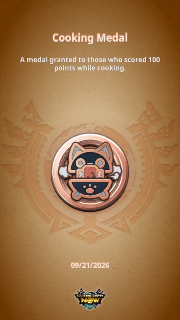 Medal z gry Monster Hunter Now z napisem Cooking Medal oraz opisem o zdobyciu 100 punktów podczas gotowania.